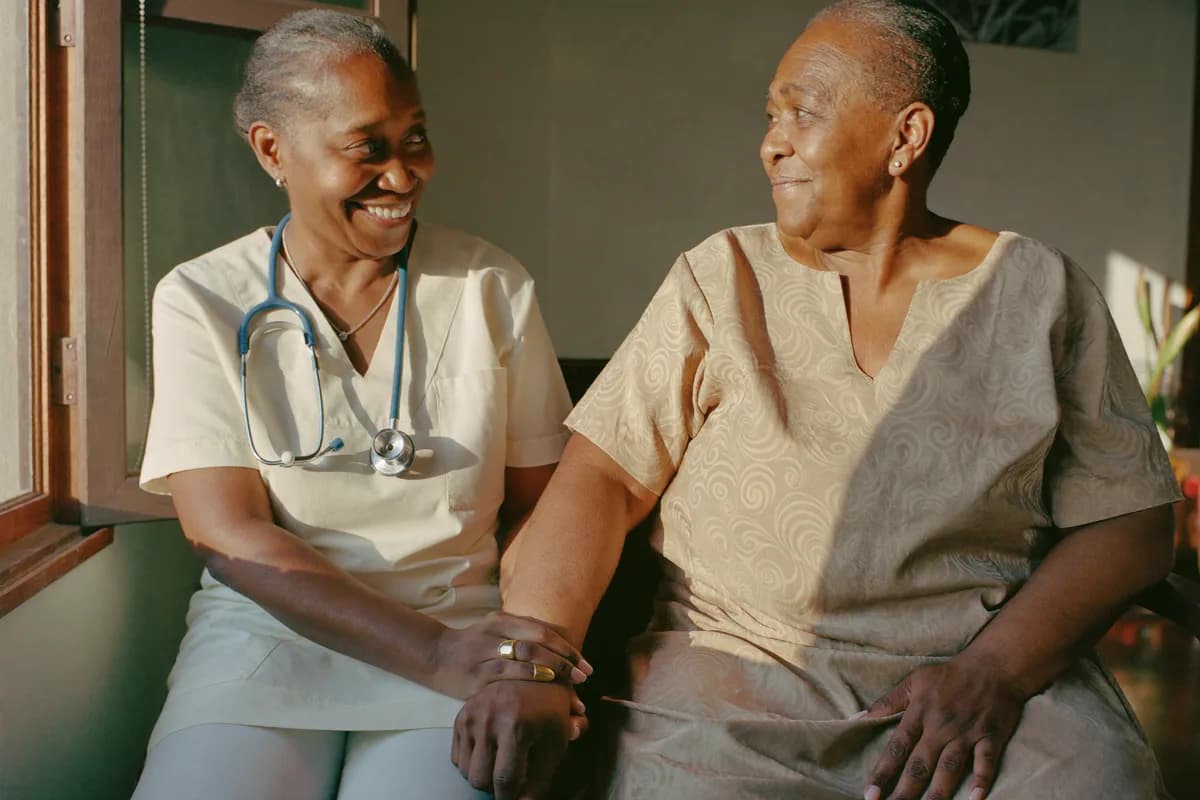 A nurse checking in on a member at home in Nigeria