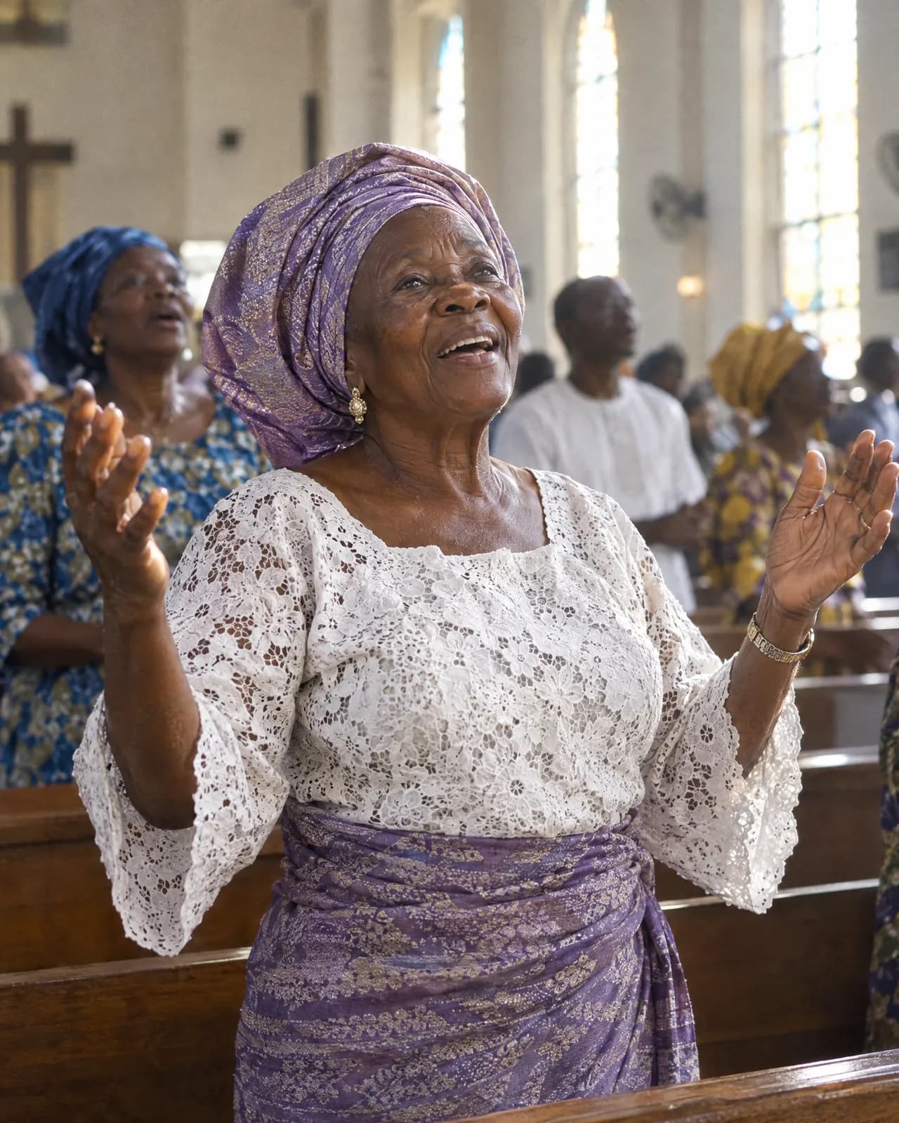 An older woman singing with her hands raised in church