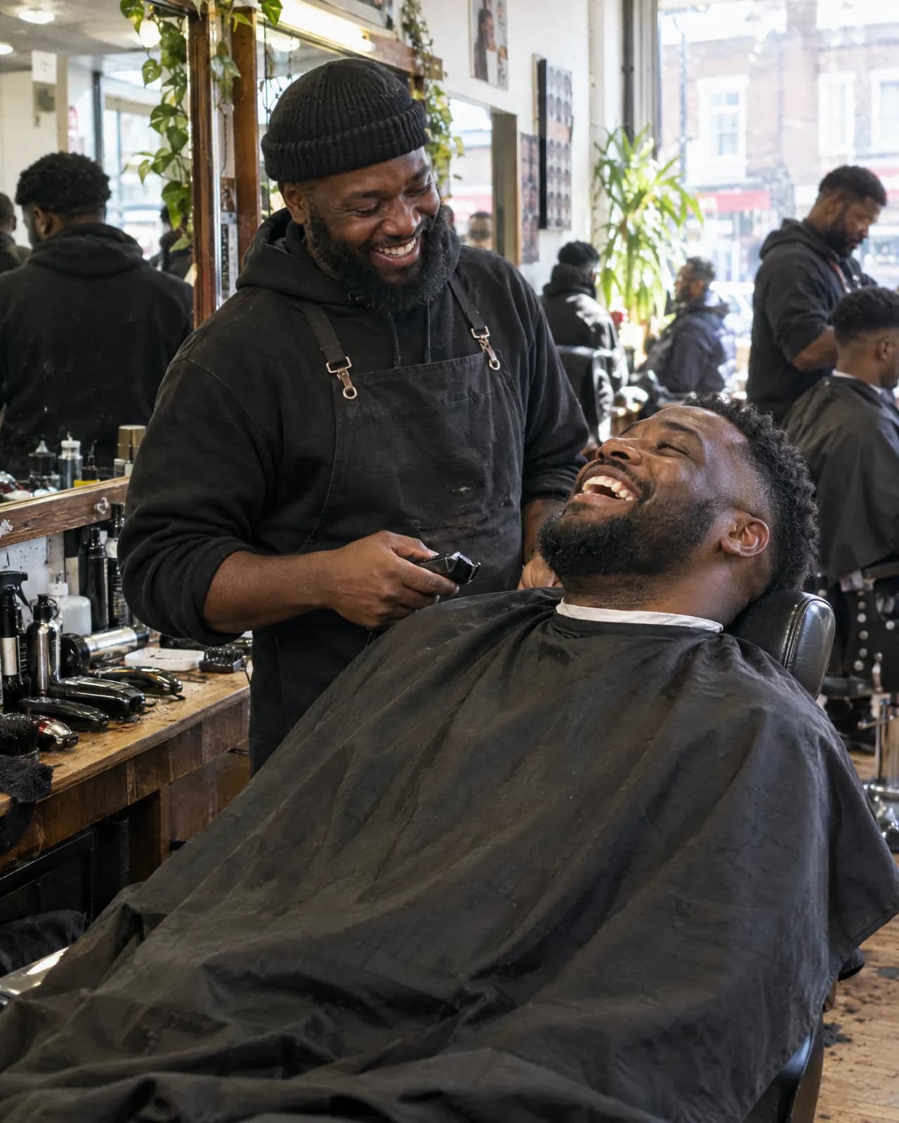 A man laughing in the barber's chair
