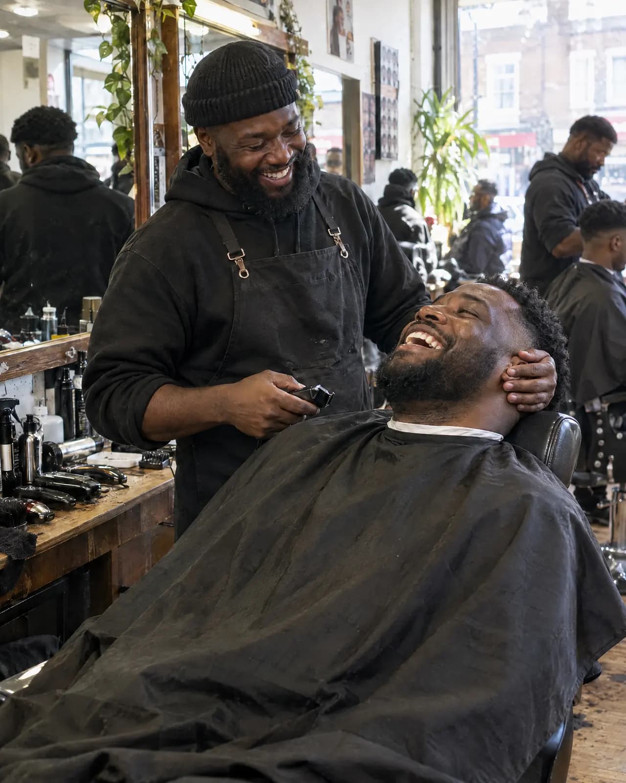 A man laughing in the barber's chair