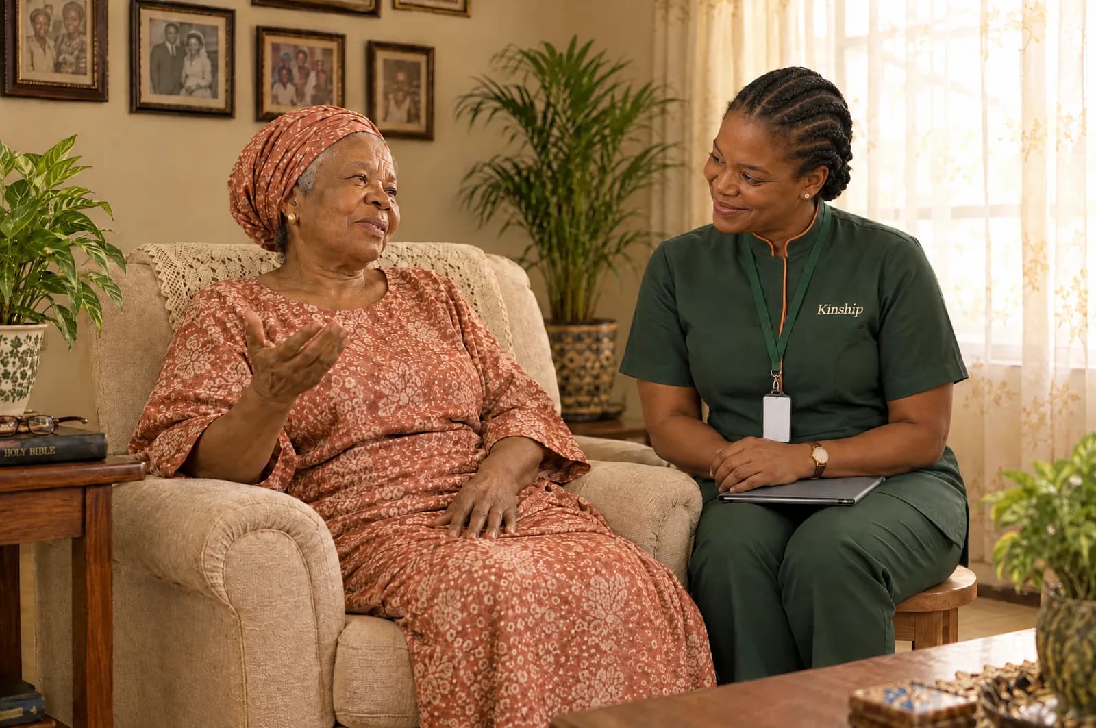 A Kinship nurse sitting beside an older woman in her living room, listening as she talks