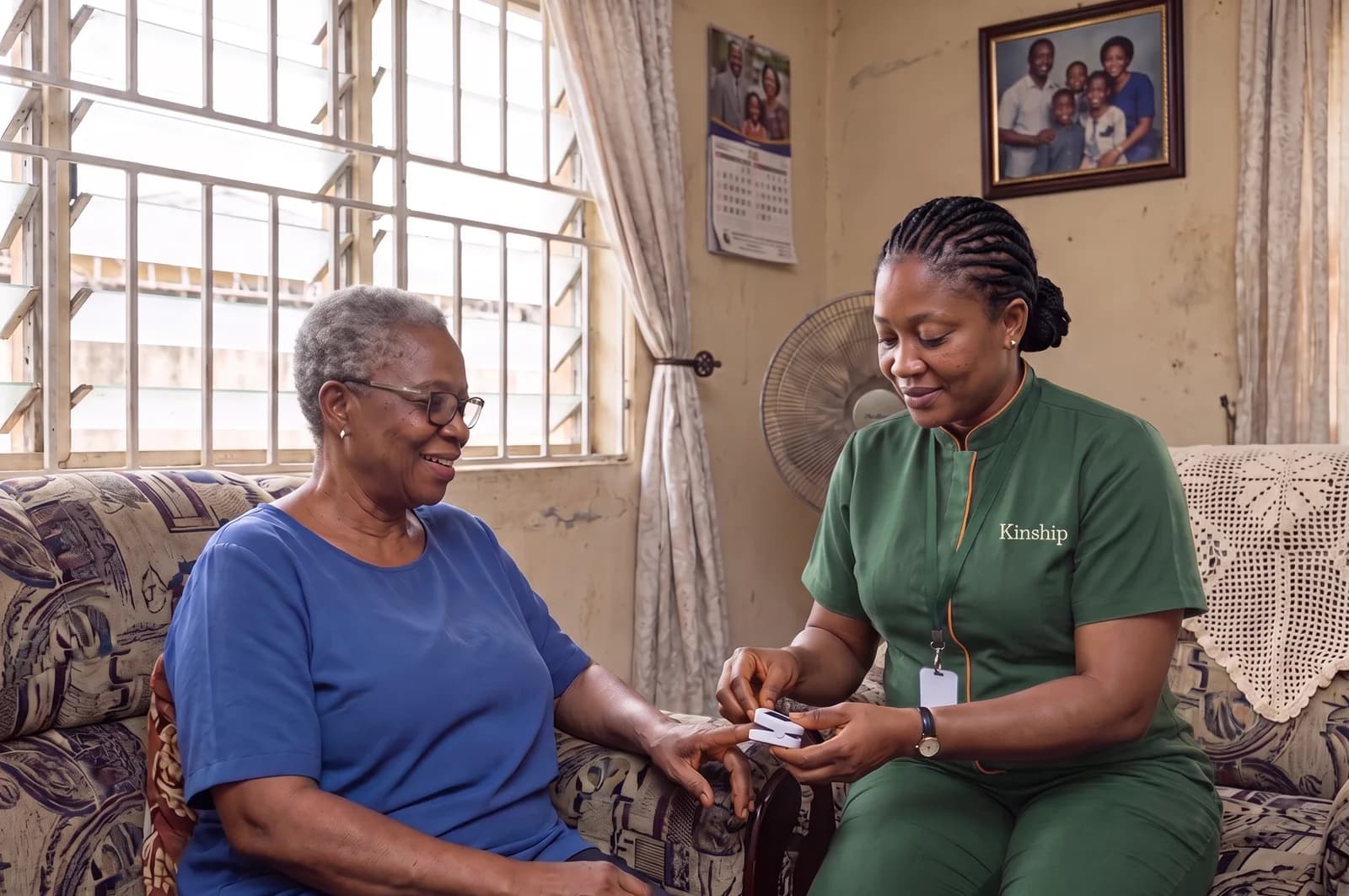A Kinship nurse taking a reading from an older woman's finger in her living room in Yaba